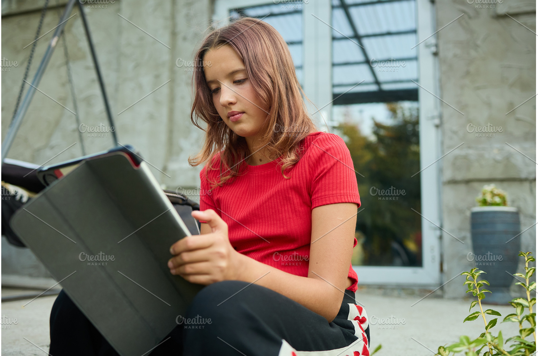 School girl uses tablet while, a School & Education Photo by IlliaBondarPhotography