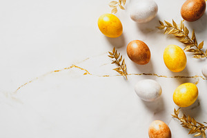 Happy Easter flat lay composition with luxury decorated Easter egg and golden b
