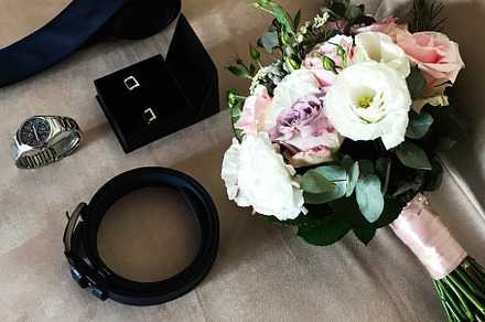 Elegant wedding accessories with bouquet, tie, belt, and watch, a Photo by AS photostudio