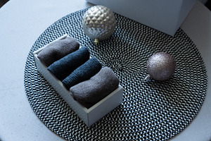 Cozy holiday gift with folded textiles and Christmas ornaments, an Industrial Photo by MDBildes