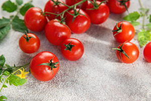Fresh cherry tomatoes on vine with green leaves, a Food & Drink Photo by Olena Rudo