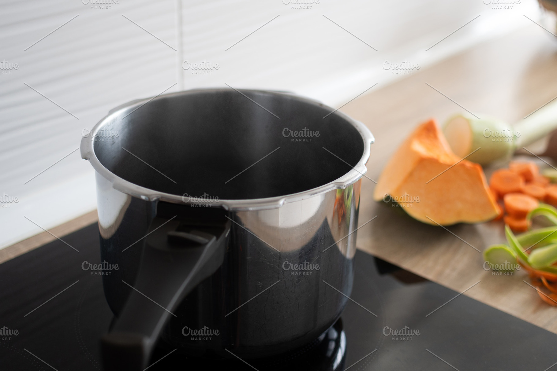 Empty cooking pot on stovetop with fresh vegetables in kitchen, a Food & Drink Photo by etorres69