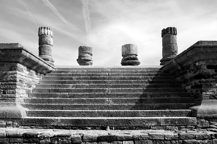 Roman ruins featuring stairs, columns, and ruins