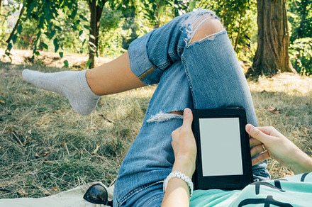 Girl reading a book in summer Park l, a Technology Photo by progressman