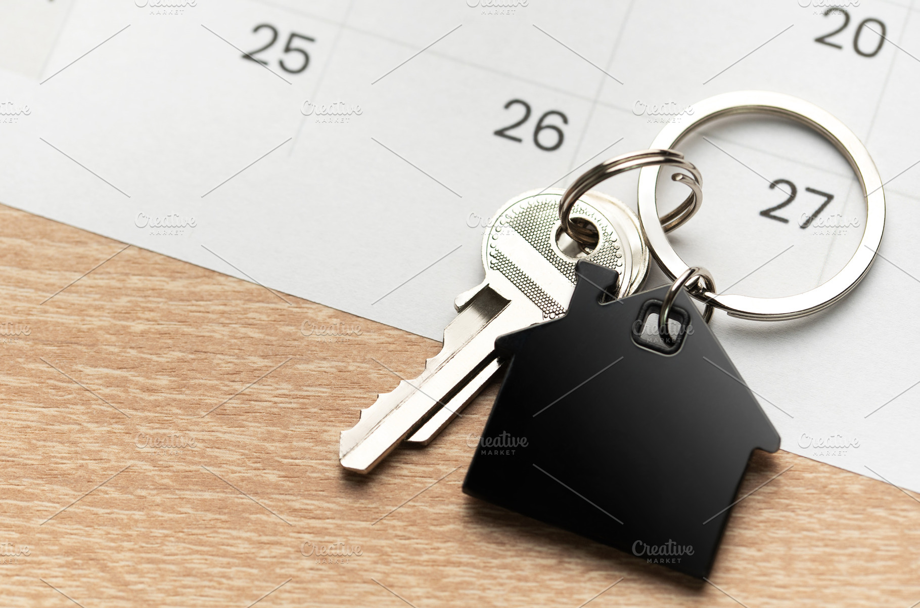 House key with keychain on calendar showing important date, a Business Photo by Olena Rudo
