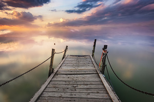 Wooden Pier Over a Misty Lake with a, a Background Photo by Perpis