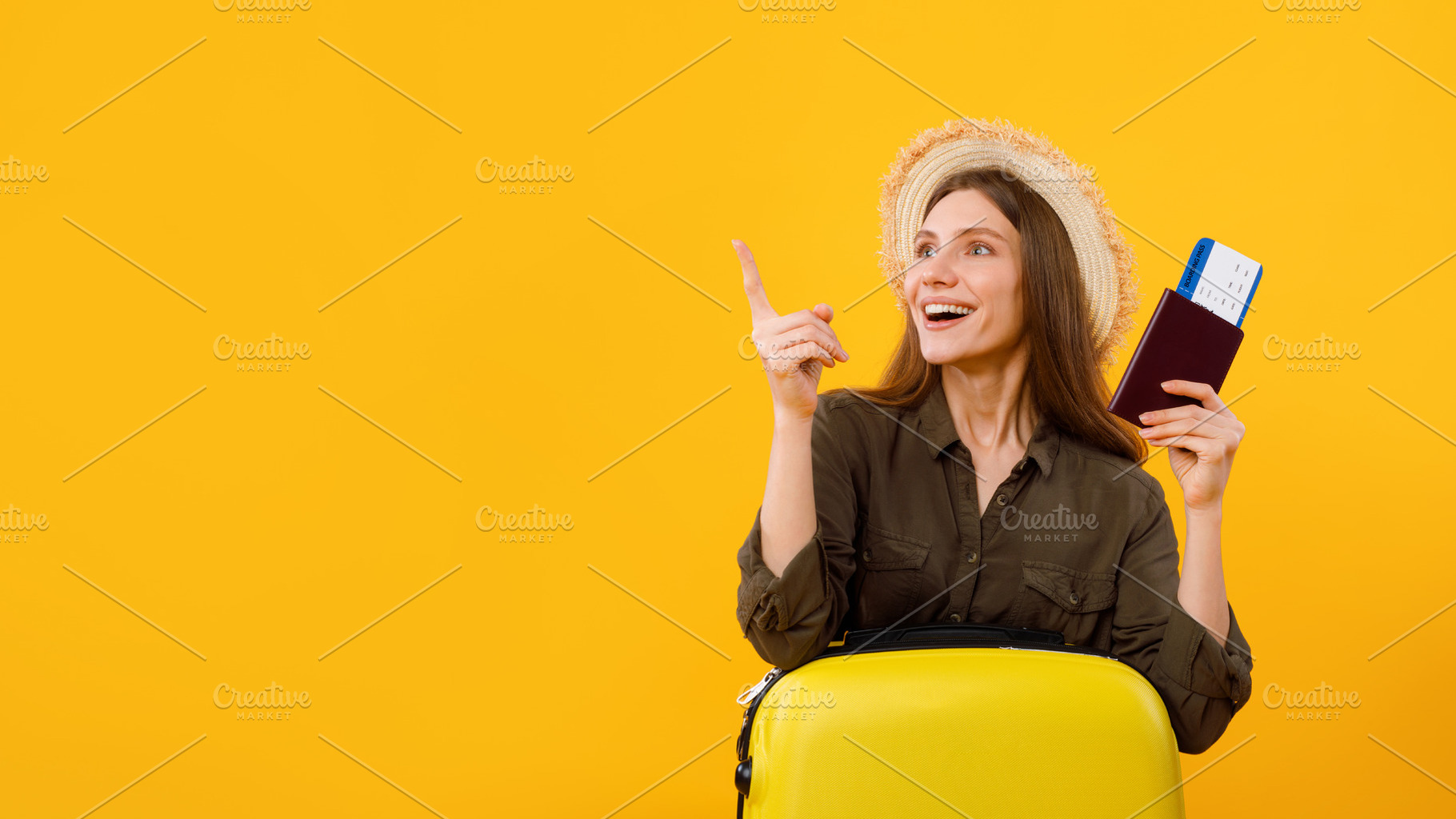 Excited Woman Tourist Pointing Fingers Aside Over Yellow Background, a Photo by Prostock-Studio