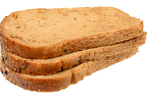 Three slices of whole grain bread with seeds stacked. Product on, a Food & Drink Photo by ndanko