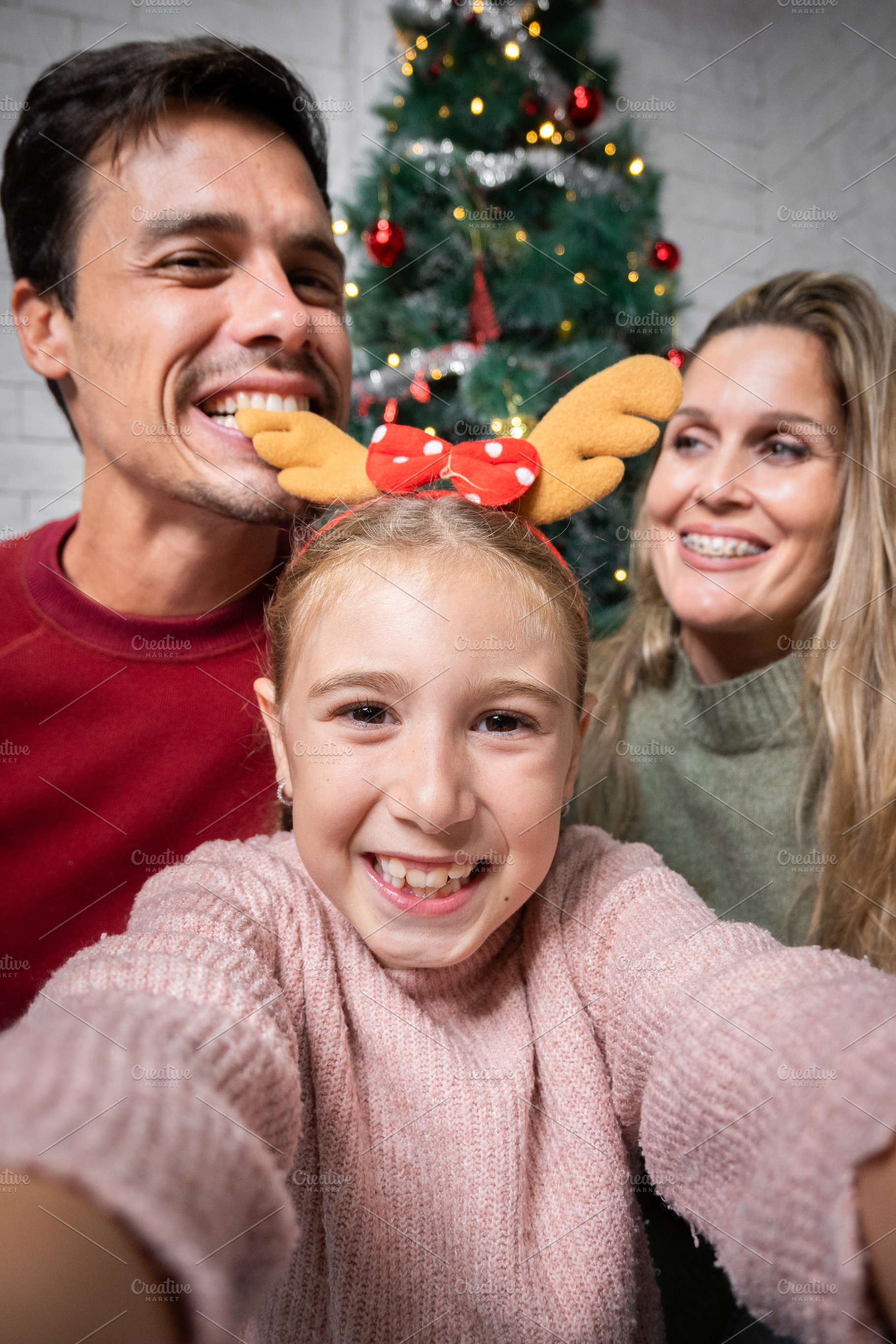 Happy family taking a Christmas selfie together at home, a Person Photo by etorres69