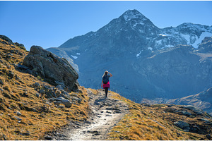 Young woman with backpack hiking, a Nature Photo by den-belitsky