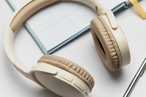 Wireless headphones, planner, eyeglasses and pen lying on white, a Technology Photo by Olena Rudo