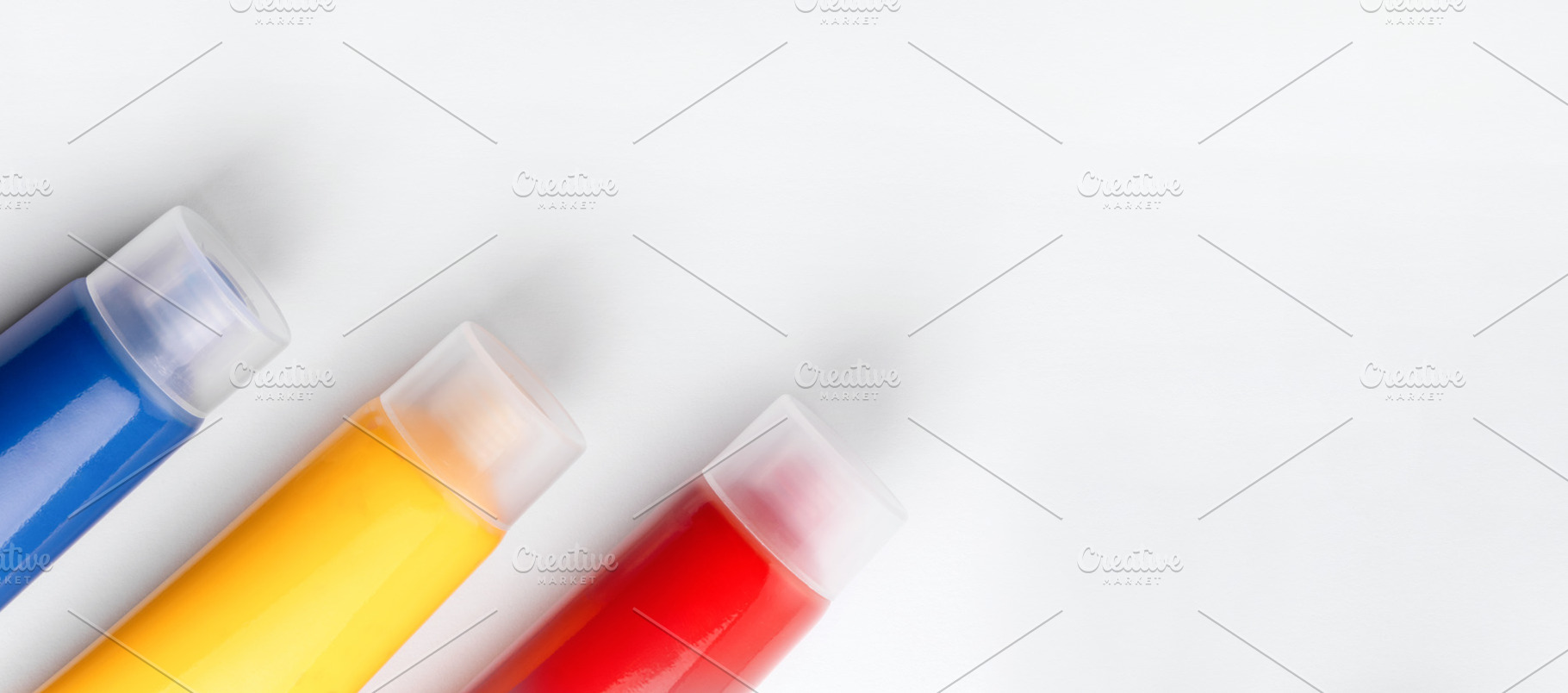 Three tubes of blue, yellow, and red paint arranged diagonally o, a Holiday Photo by Ales Munt