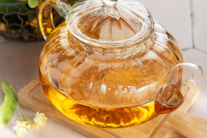 Linden tea brewing in glass teapot with lime blossom, a Food & Drink Photo by Olena Rudo