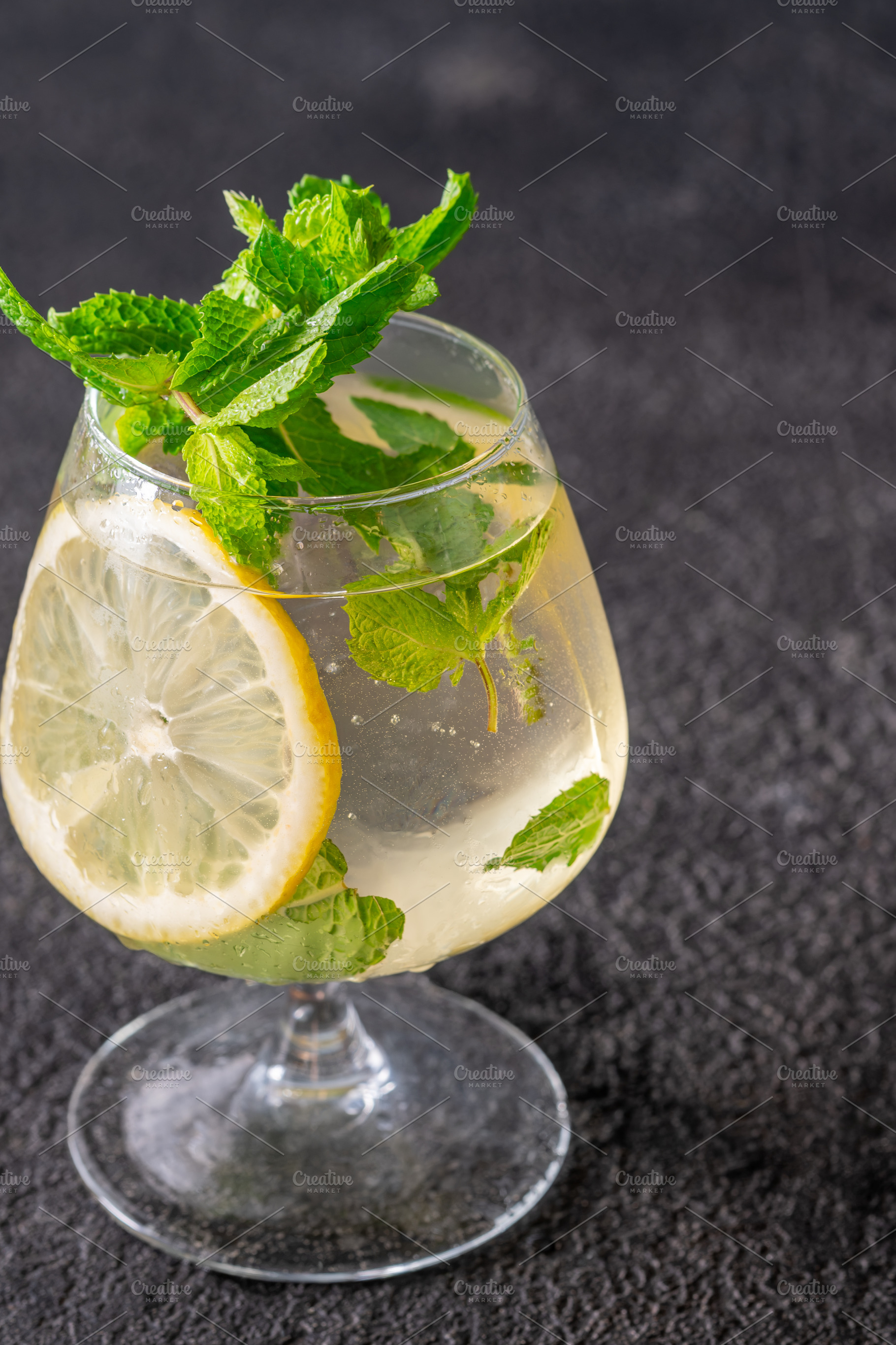Refreshing Hugo Spritz cocktail with lemon mint ice bubbles and, a Food & Drink Photo by Alexander Prokopenko