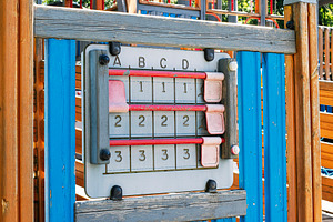 Colorful interactive abacus-style educational panel in a children's playground, a Photo by AS photostudio