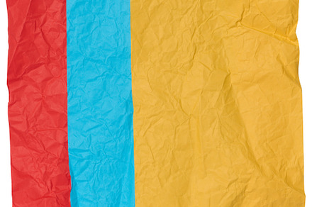 Yellow, blue and red crumpled sheets of paper on a white backgro, an Abstract Photo by ndanko