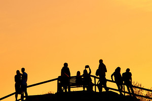 Silhouettes group people sunset park featuring people, city, and background