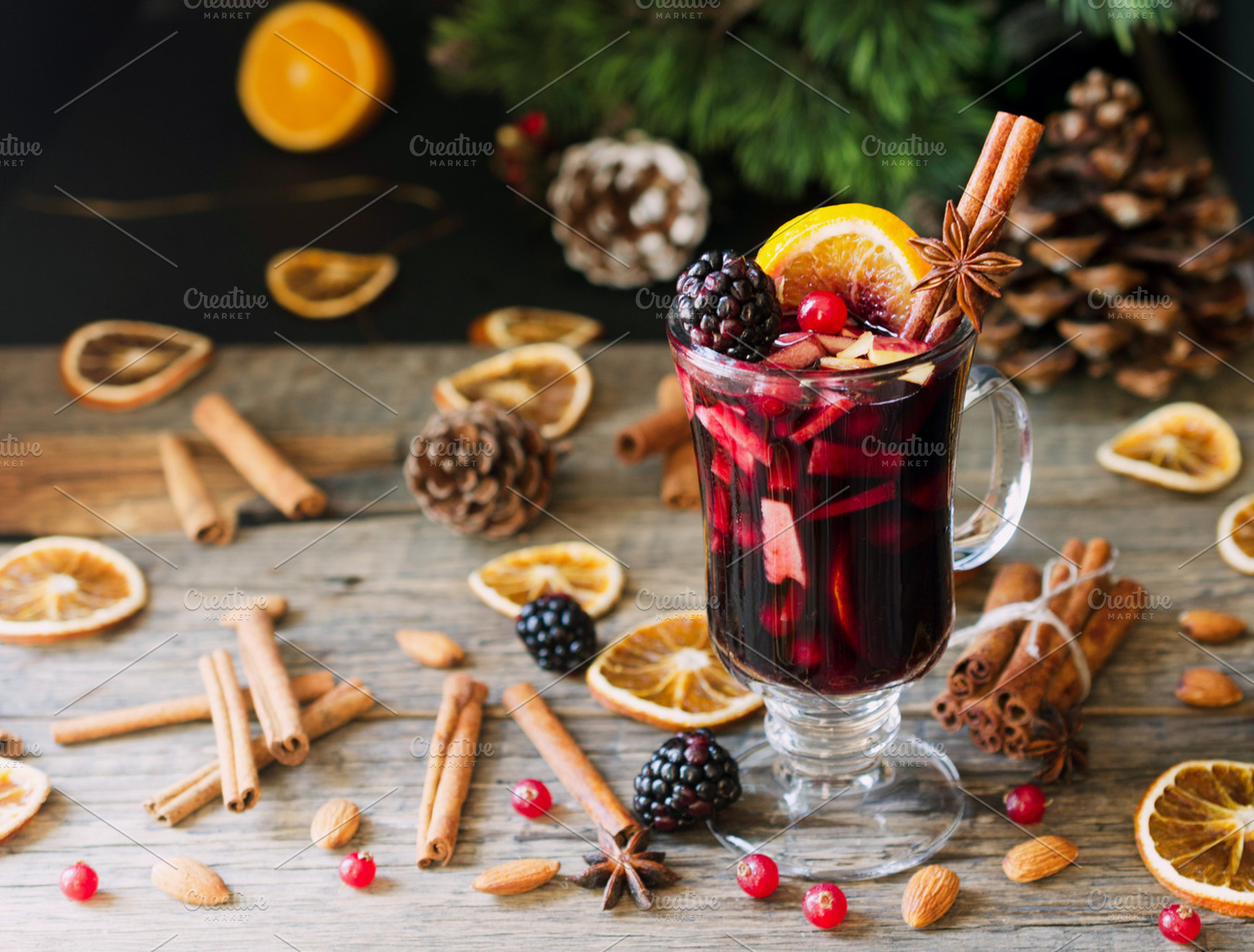 Glass of hot mulled wine for the new year with ingredients for cooking nuts, a Food & Drink Photo by Wild Drago Shop