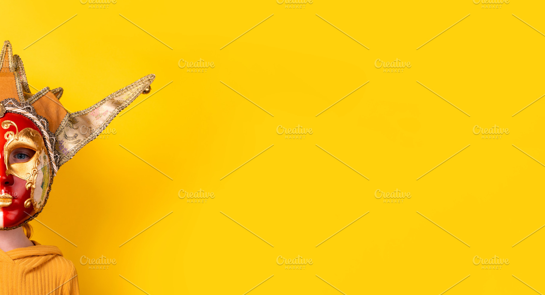 Person in ornate Venetian mask and costume on vibrant yellow bac, a Holiday Photo by Ales Munt