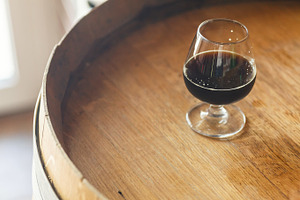 Glass of stout on a barrel