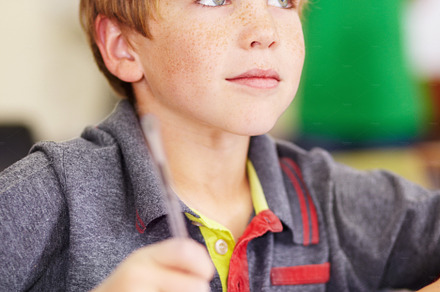 Listening intently to his teacher, a Photo by Peopleimages.com