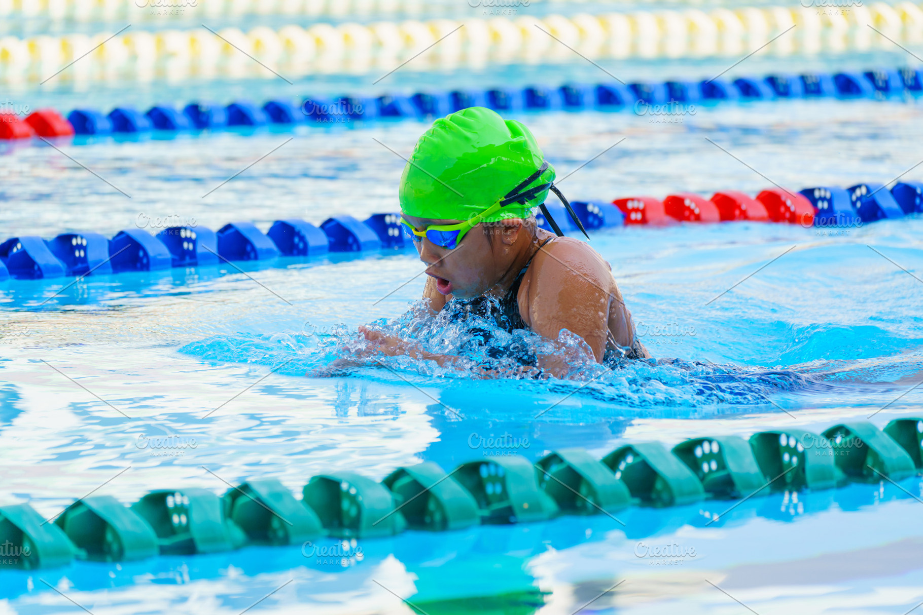 Swimmer child swims breaststroke swimming style in a race swimmi, a Sports & Recreation Photo by Casanowe-studio