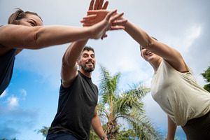Friends giving a high five after exercising together in a park., a Sports & Recreation Photo by etorres69