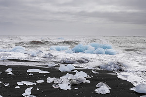 Black sand beach with ice containing mountains, beauty, and arctic