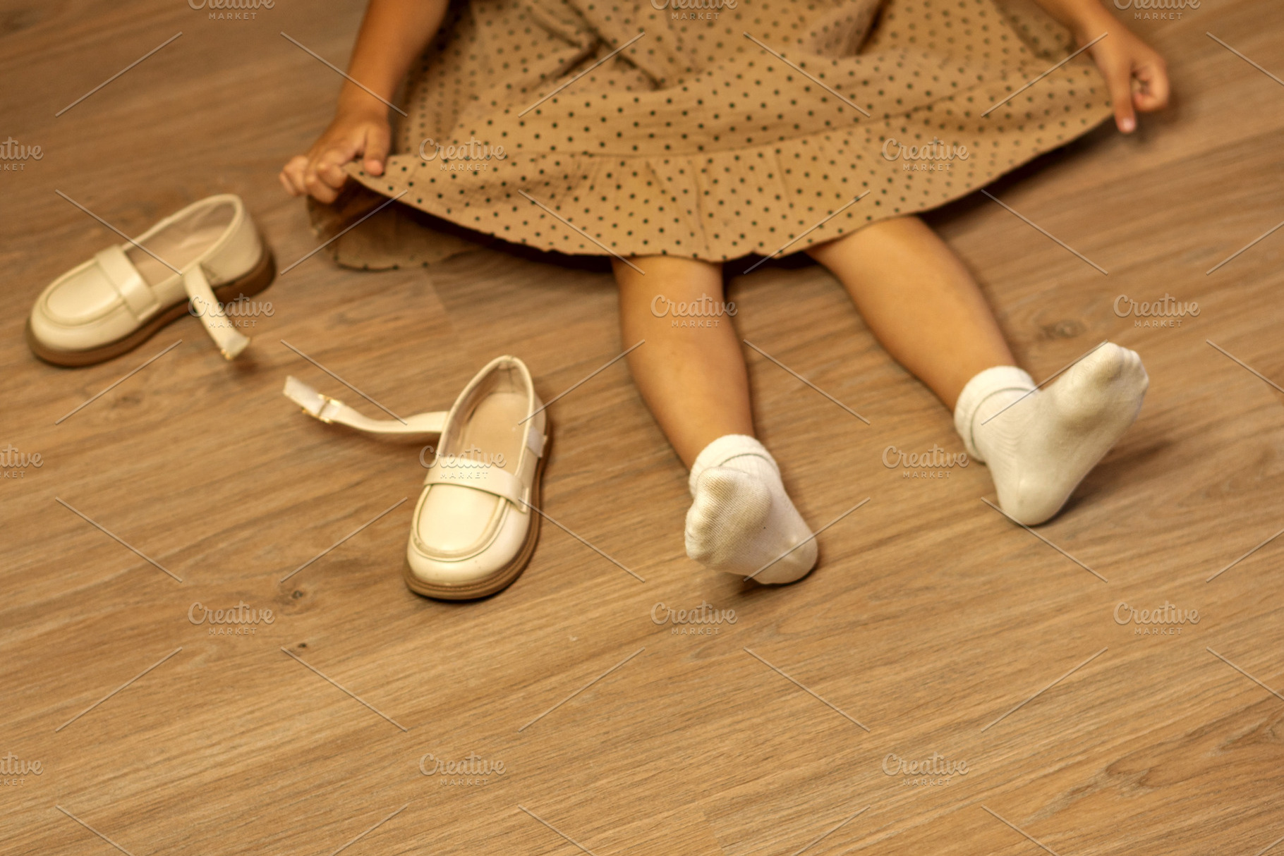 Child sitting on floor with beige, a Wallpaper Photo by Elena Vagengeim