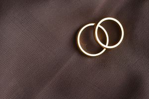 Overlapping Gold Rings on Dark Brown Fabric, an Abstract Photo by Davizro's Market