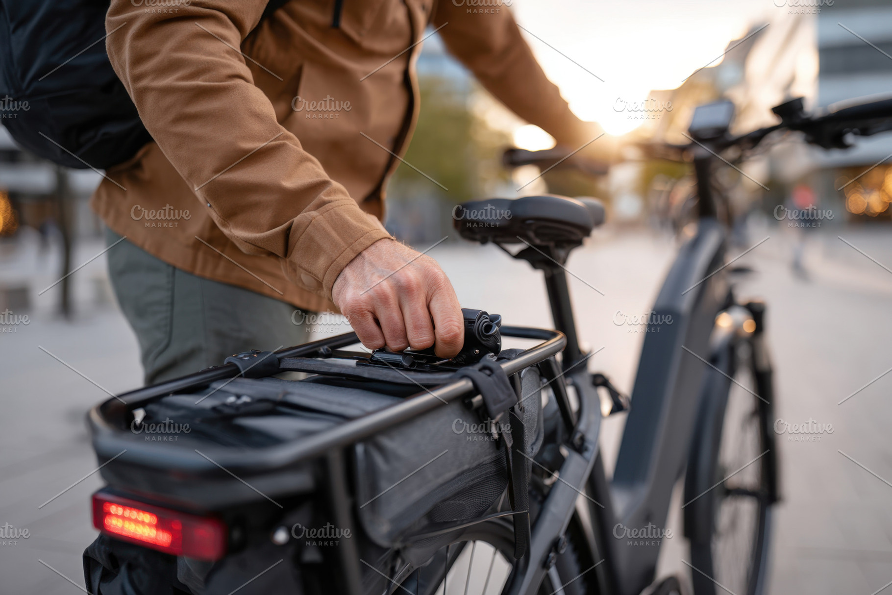 Adjusting bag on electric bike in urban setting, a Transportation Photo by AlyaAnd