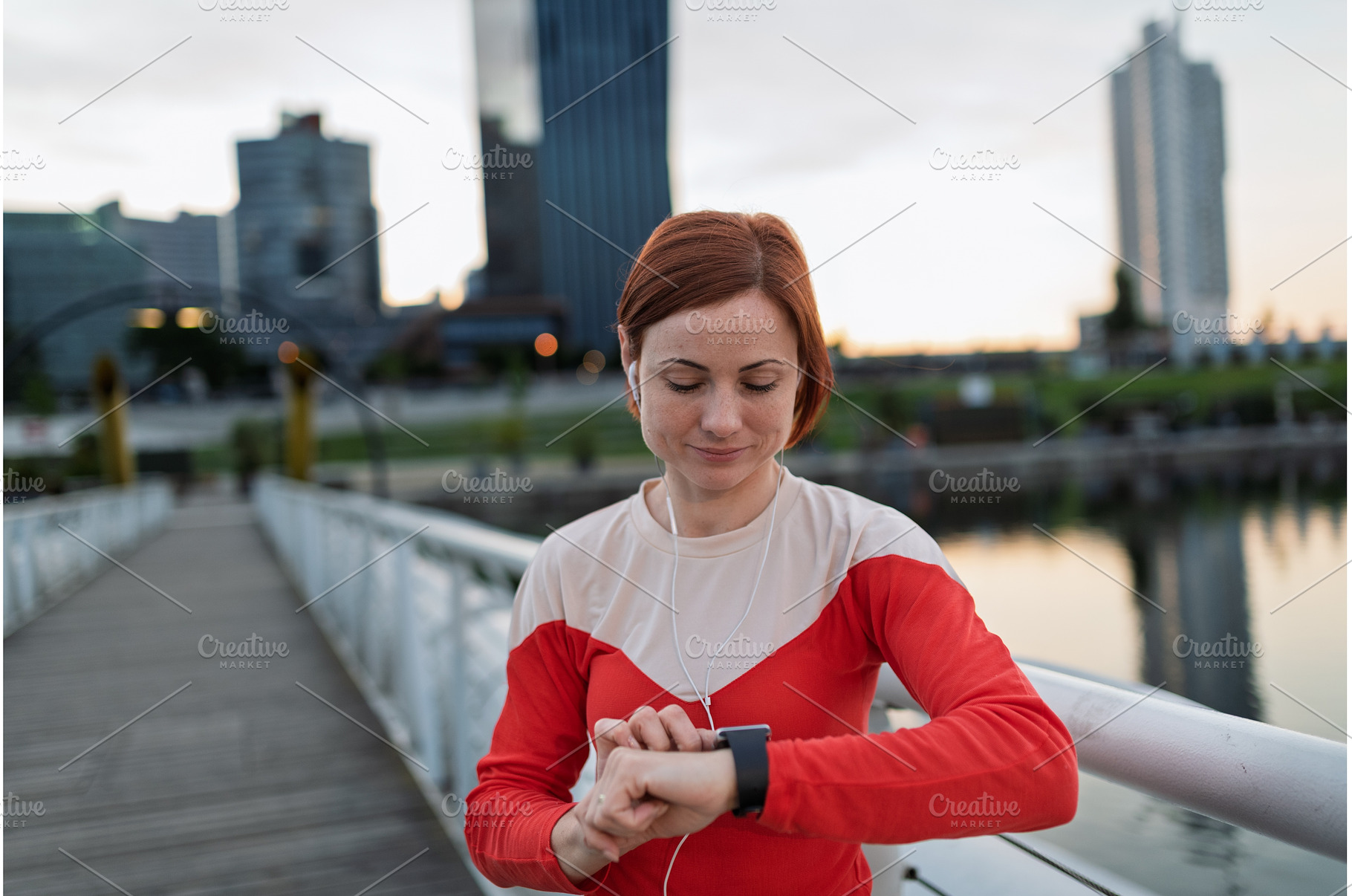 Runner checking her performance on a, a Sports & Recreation Photo by HalfPoint