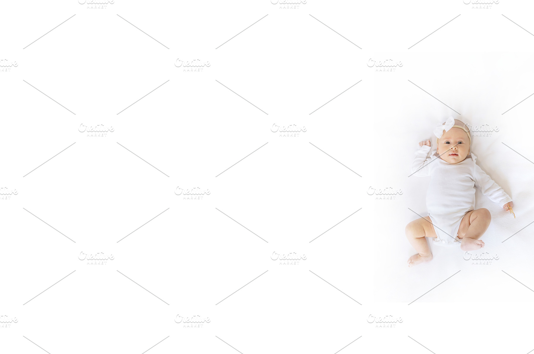 A newborn baby lies on a white bed, a Person Photo by yanadjana
