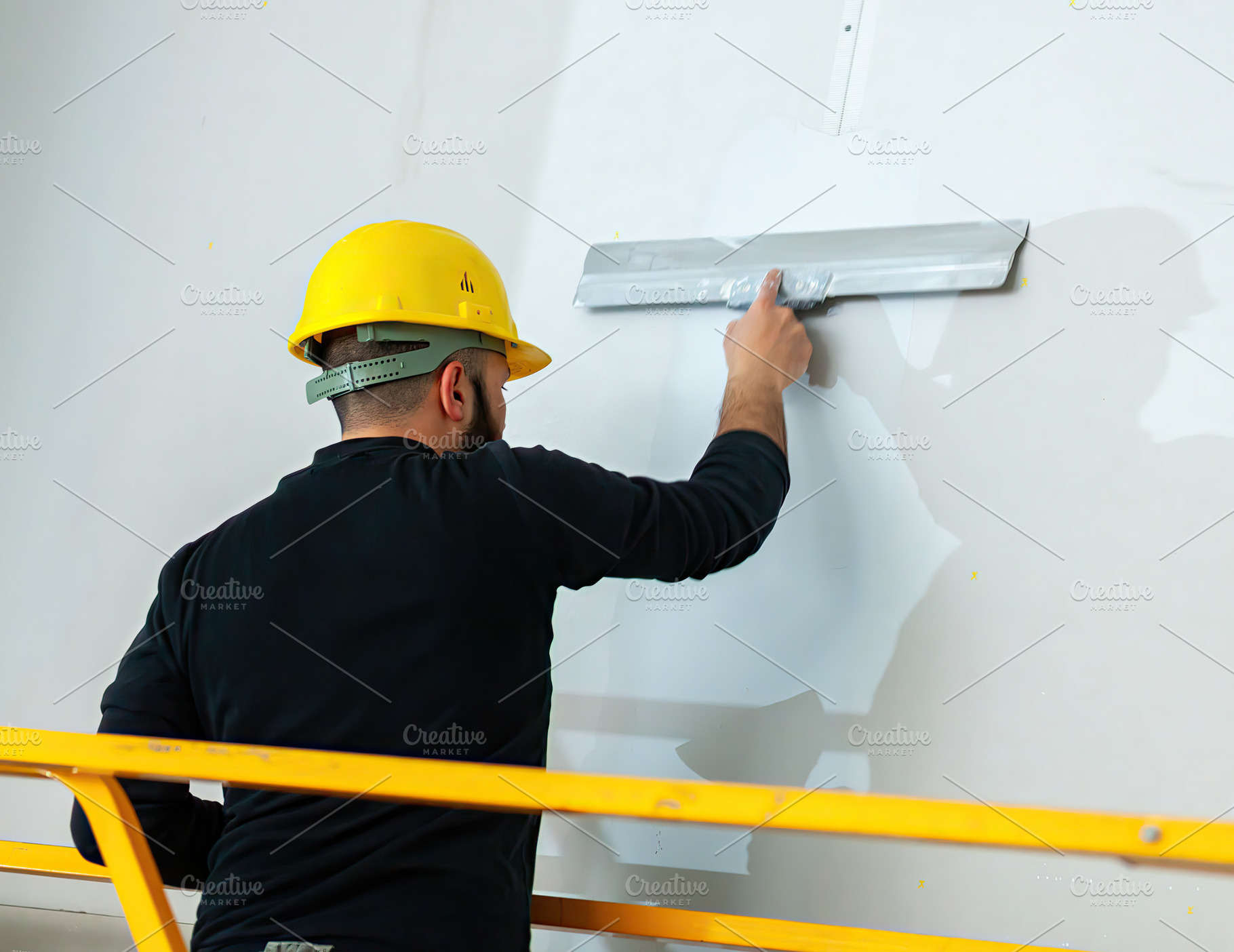 Construction worker applying plaster on a wall using a spatula, an Industrial Photo by Antonio Gravante Market