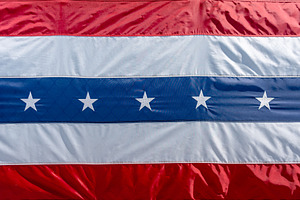 Close-up of a red, white, and blue patriotic flag with stars. US, a Photo by GoodGoods