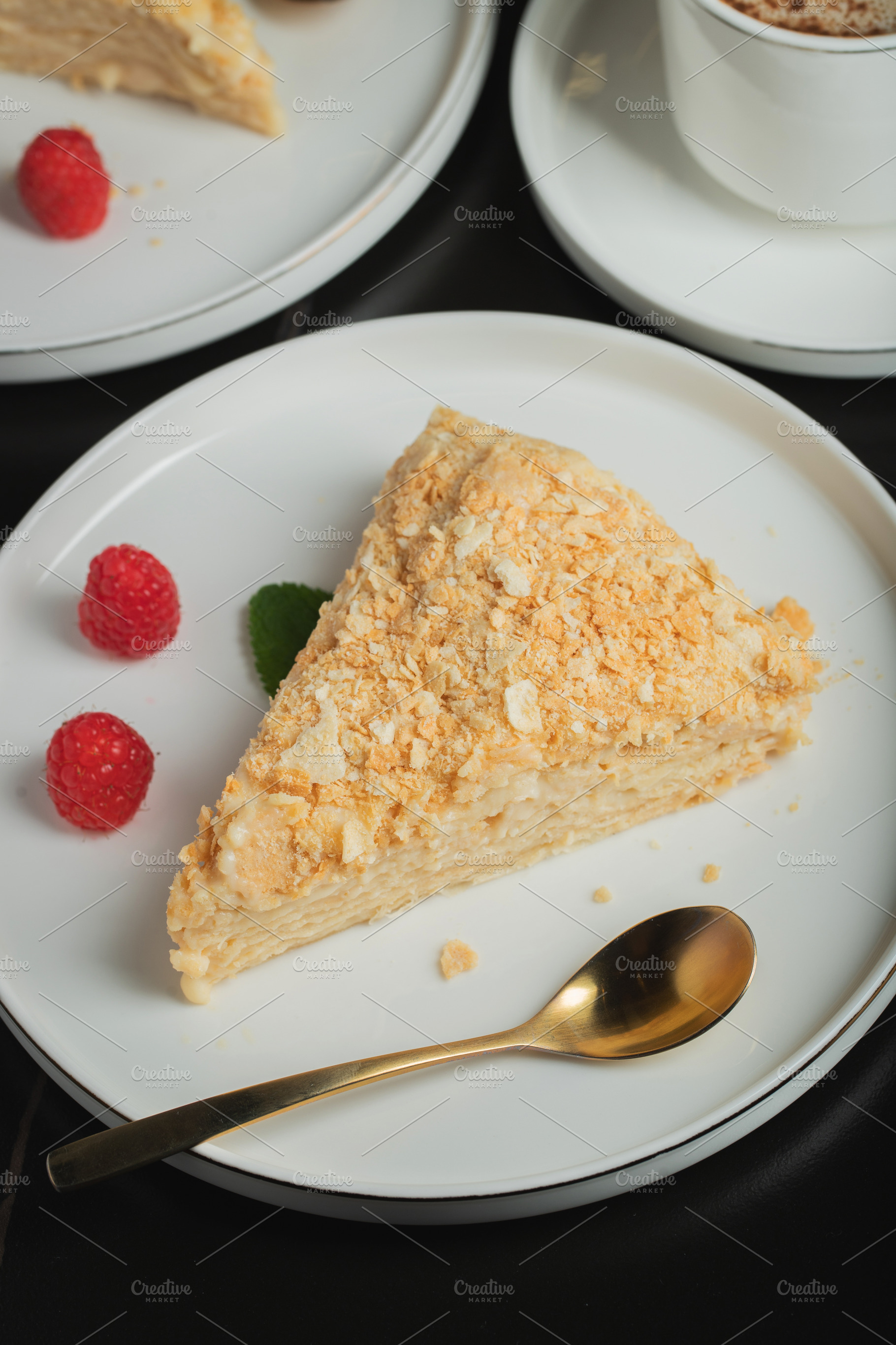 Sliced Napoleon cake on a white wooden table. Classic dessert, a Food & Drink Photo by Budarinphoto