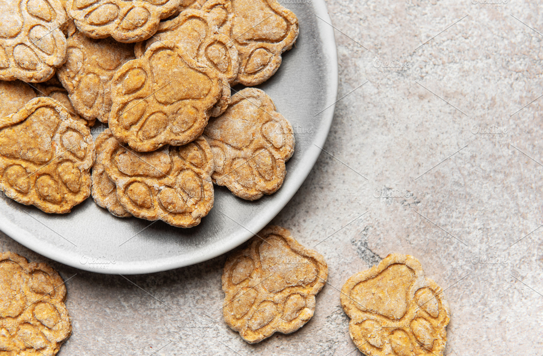 Homemade paw print dog treats on a plate, a Food & Drink Photo by Olena Rudo