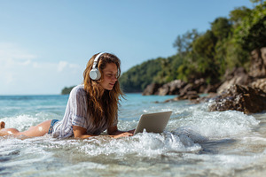 Digital nomad - Young woman on beach, a Technology Photo by MistyDay