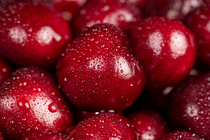 cherry berries in drops of water, wet red cherry fruits on the kitchen table cl, a Photo by rsoollAI