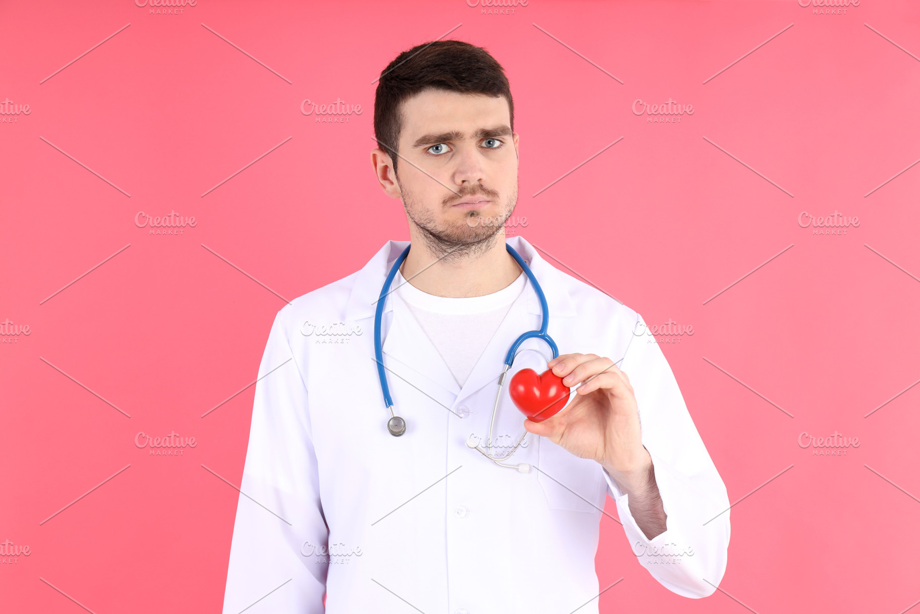 Doctor - intern with heart on pink background, a Person Photo by AtlasStudio