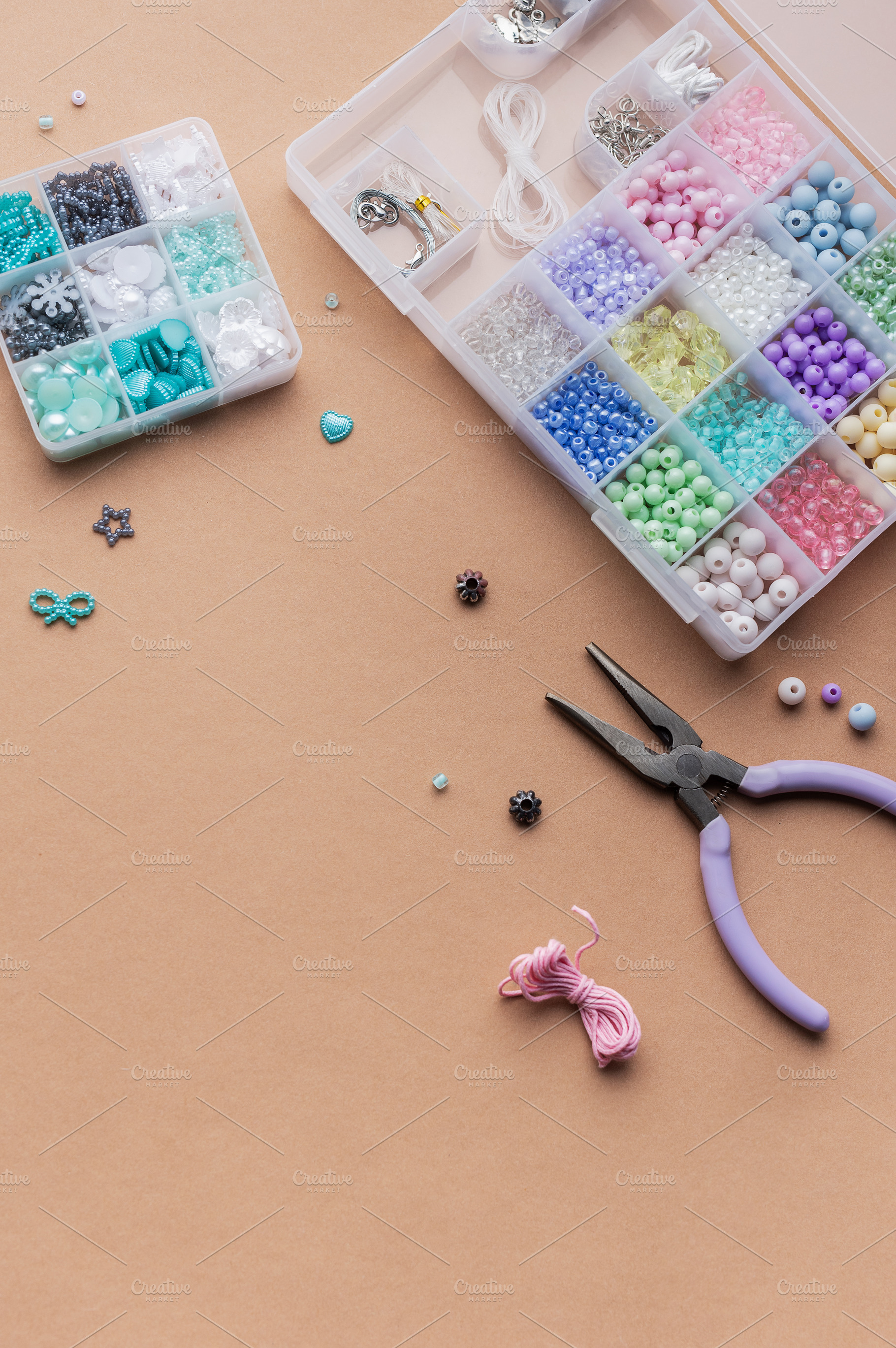 Crafting with colorful beads on a flat workspace with tools and, an Arts & Entertainment Photo by Olena Rudo