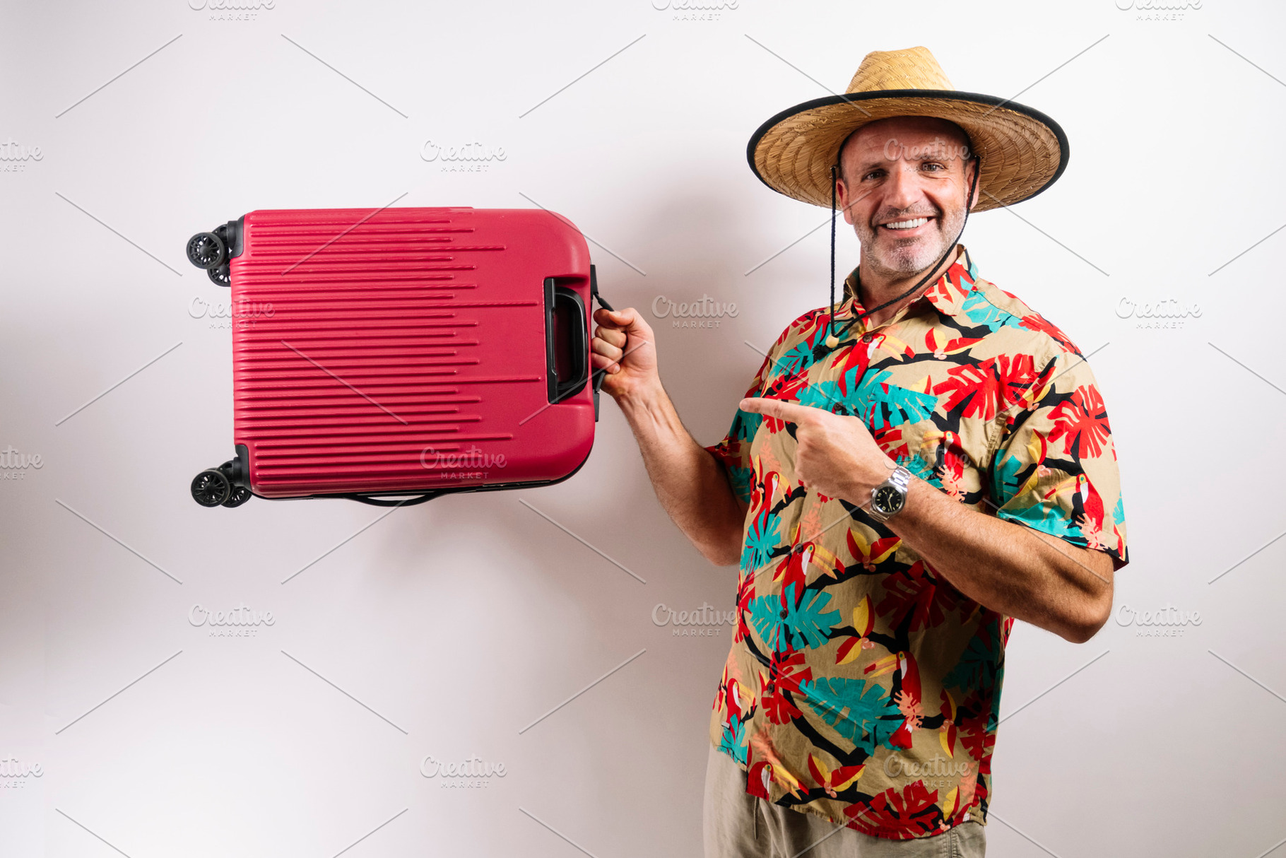 Man ready for vacation with red suitcase, a Person Photo by karrastock