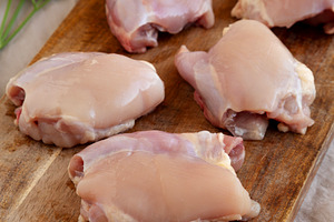 Raw Organic Boneless Skinless Chicken Thighs on a Wooden Board,, a Food & Drink Photo by LiudmylaChuhunova