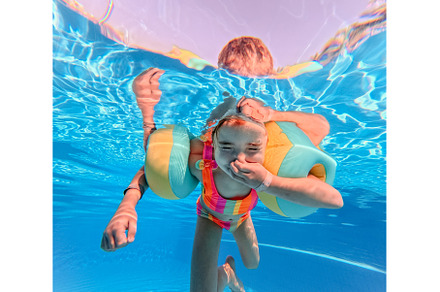 Little girl in swimsuit diving in, a Sports & Recreation Photo by HalfPoint