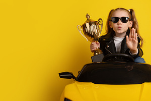 Young girl in black leather jacket and sunglasses sitting in a y, a Person Photo by Ales Munt