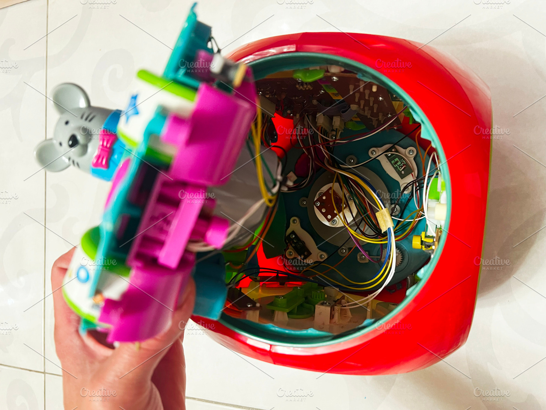 Close-up of dismantled toy showing colorful circuits and internal mechanical co, a Photo by AS photostudio