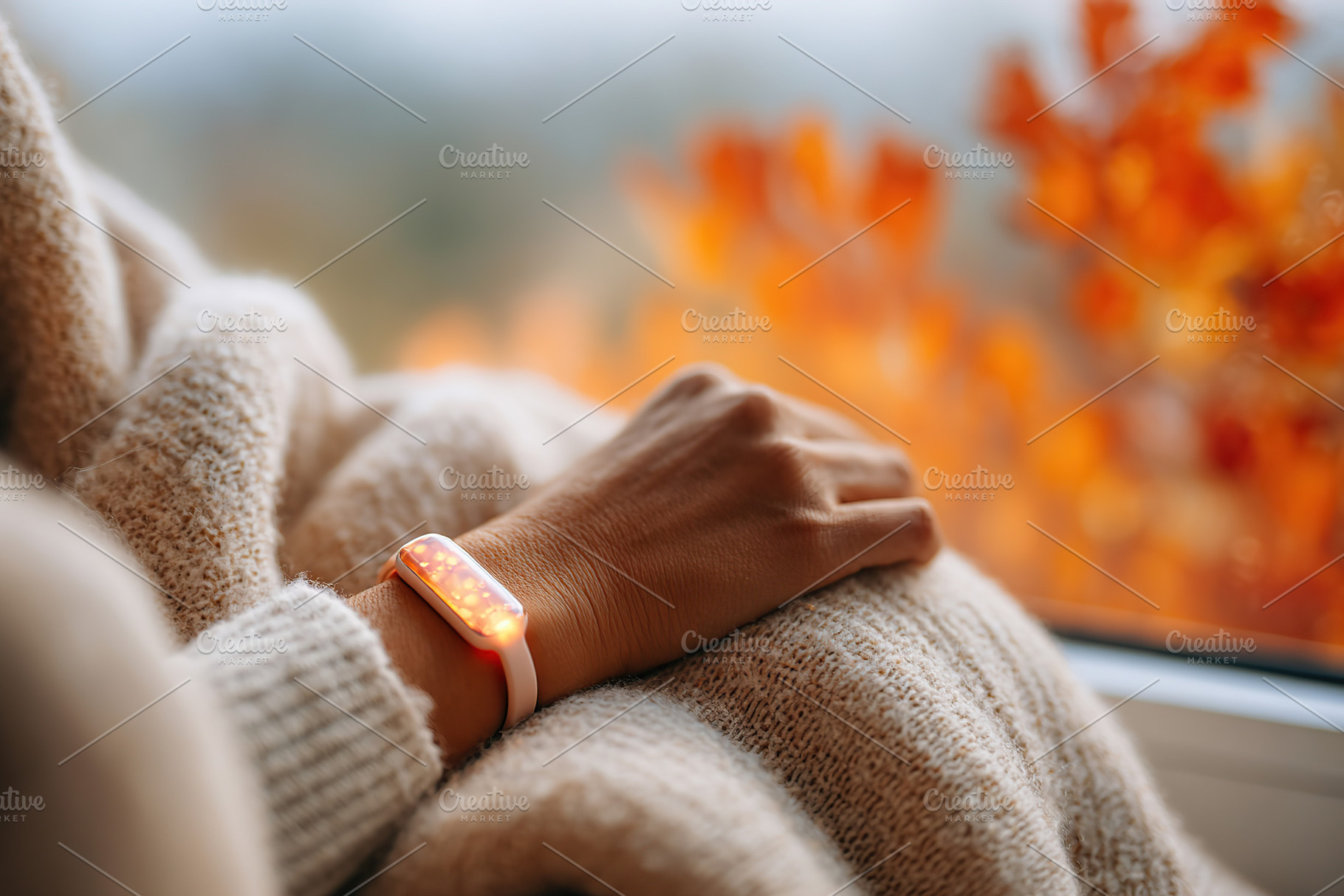 Tracker softly glowing on wrist while resting near window on an autumn day, a Photo by AlyaAnd