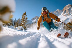Skier carving through fresh snow in the mountains, a Sports & Recreation Photo by AlyaAnd