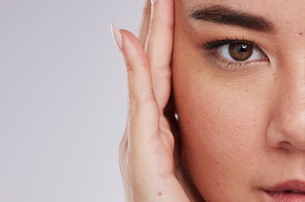 Skincare, portrait and woman in studio for beauty, grooming and cosmetic on grey background. Face, half and closeup of asian girl model relax, eye lift and anti aging skin treatment isolated, a Photo by Peopleimages.com