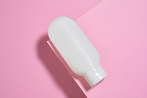 White plastic cosmetic tube on a pink background. Top view, a Beauty & Fashion Photo by ndanko